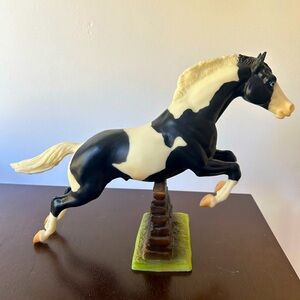 Traditional Breyer horse. Black and white jumping. Shelf condition.